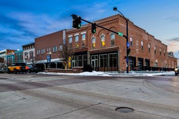 A street view of a city intersection with a traffic light showing green at The Avenue Lofts Golden Apartments, Golden, Colorado